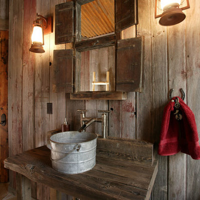 Powder room - rustic powder room idea in Denver with a vessel sink, wood countertops and brown countertops