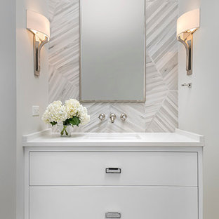 Example of a mid-sized transitional gray tile and porcelain tile porcelain tile powder room design in Chicago with flat-panel cabinets, white cabinets, a wall-mount toilet, gray walls, an undermount sink and quartz countertops