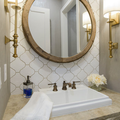 Inspiration for a transitional white tile and ceramic tile powder room remodel in Wichita with gray walls, a drop-in sink and beige countertops
