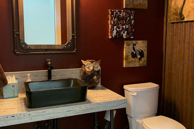 Powder room - small rustic red tile and metal tile porcelain tile and gray floor powder room idea in Albuquerque with a one-piece toilet, red walls, a vessel sink, granite countertops and beige countertops