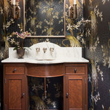 Example of a classic mosaic tile floor and black floor powder room design in Minneapolis with recessed-panel cabinets, dark wood cabinets, multicolored walls, an undermount sink and white countertops