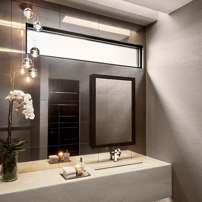 Powder room - contemporary black tile powder room idea in Phoenix with an integrated sink and gray walls