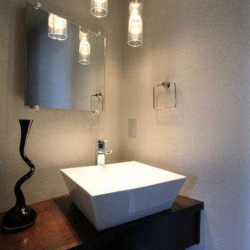 Modern powder bathroom with floating cabinet + vessel sink