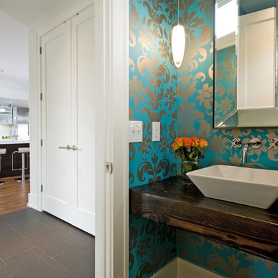 Trendy powder room photo in Minneapolis with a vessel sink and brown countertops