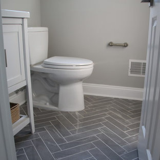 Powder room - small transitional marble floor and gray floor powder room idea in New York with shaker cabinets, white cabinets, a two-piece toilet, gray walls, an undermount sink and quartz countertops