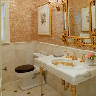 Powder room - mid-sized traditional marble tile beige floor and marble floor powder room idea in Boston with a one-piece toilet, multicolored walls, a console sink and marble countertops