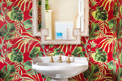 Design ideas for a small cloakroom in Boston with red walls, marble flooring, a pedestal sink, green floors and wallpapered walls.