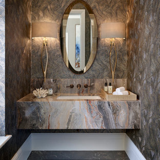 Mid-sized contemporary powder room in Berkshire with marble floors, an undermount sink and black floor.