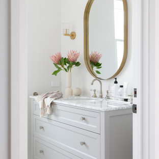 This is an example of a transitional powder room in Canberra - Queanbeyan with shaker cabinets, grey cabinets, white tile, porcelain tile, mosaic tile floors, marble benchtops, white floor, grey benchtops, a freestanding vanity, white walls and an undermount sink.
