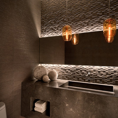 Trendy stone tile powder room photo in Phoenix with an integrated sink and gray countertops