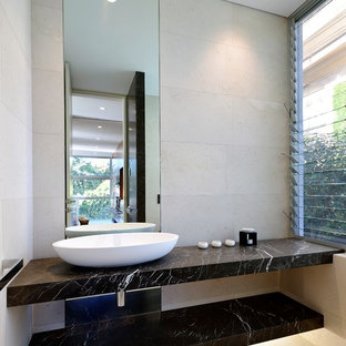 Design ideas for a contemporary powder room in Sydney with beige walls, a vessel sink and beige floor.