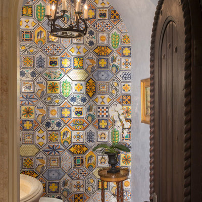 Small tuscan multicolored tile and ceramic tile terra-cotta tile and brown floor powder room photo in Miami with furniture-like cabinets, gray walls and a pedestal sink
