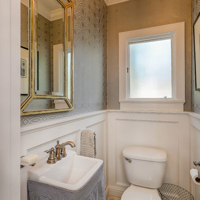 Inspiration for a small transitional marble floor and white floor powder room remodel in Santa Barbara with a two-piece toilet, gray walls, a pedestal sink, solid surface countertops and white countertops