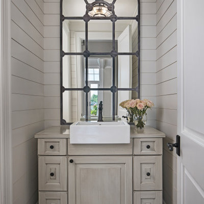 Inspiration for a small transitional brown floor powder room remodel in Detroit with furniture-like cabinets, beige cabinets, beige walls, a vessel sink and beige countertops