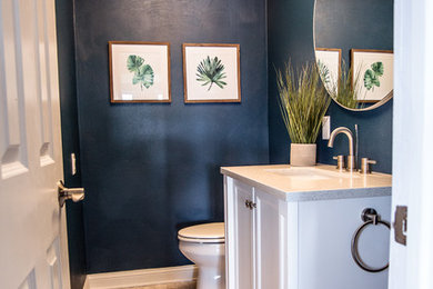 Powder room - small modern ceramic tile and multicolored floor powder room idea in Other with furniture-like cabinets, white cabinets, a one-piece toilet, blue walls, an undermount sink and quartzite countertops