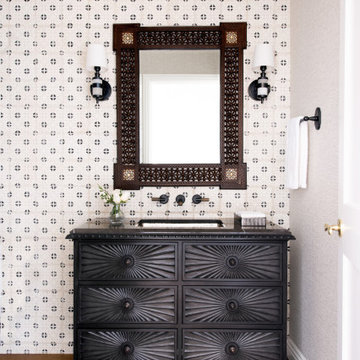 Powder Room with custom cabinetry and tiled wall