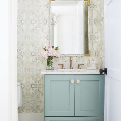 Transitional marble floor and gray floor powder room photo in Other with shaker cabinets, green cabinets, a one-piece toilet, an undermount sink, marble countertops, white countertops and multicolored walls