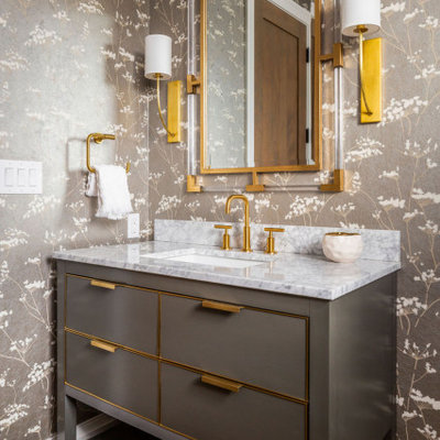Example of a mid-sized transitional wallpaper, dark wood floor and brown floor powder room design in Denver with flat-panel cabinets, marble countertops, white countertops, gray cabinets, gray walls, an undermount sink and a freestanding vanity