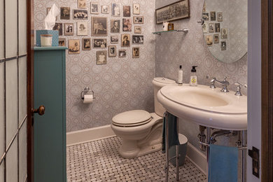 Elegant mosaic tile floor and gray floor powder room photo in Milwaukee with a two-piece toilet, gray walls and a console sink