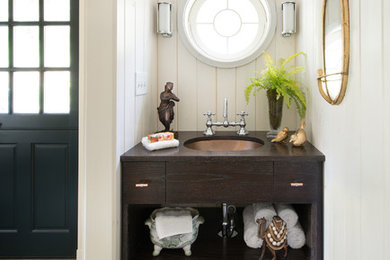 Inspiration for an eclectic powder room remodel in Philadelphia with an undermount sink, flat-panel cabinets and dark wood cabinets