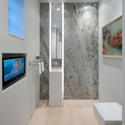 Powder room - modern gray tile marble floor powder room idea in DC Metro with a wall-mount toilet, gray walls and an integrated sink