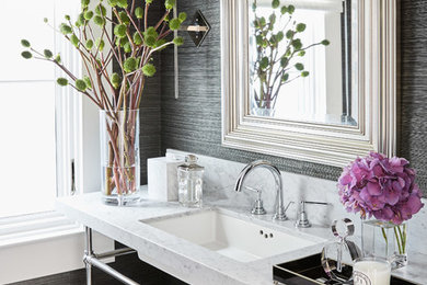 Example of a transitional powder room design in San Francisco with marble countertops, gray walls, an undermount sink and white countertops