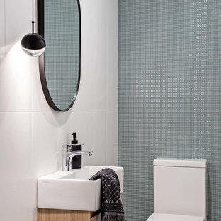 Design ideas for a small contemporary powder room in Sydney with a one-piece toilet, green tile, ceramic tile, white walls, porcelain floors, a wall-mount sink and grey floor.