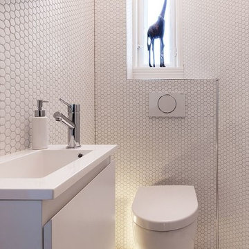 Small modern white powder room with hexagon tiles