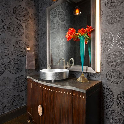 Example of a mid-sized transitional dark wood floor and brown floor powder room design in Other with furniture-like cabinets, dark wood cabinets, gray walls, a vessel sink, marble countertops and gray countertops