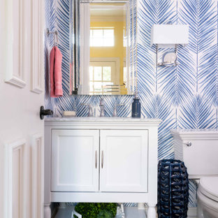 Inspiration for a small transitional dark wood floor and brown floor powder room remodel in Dallas with furniture-like cabinets, white cabinets, blue walls, white countertops and marble countertops