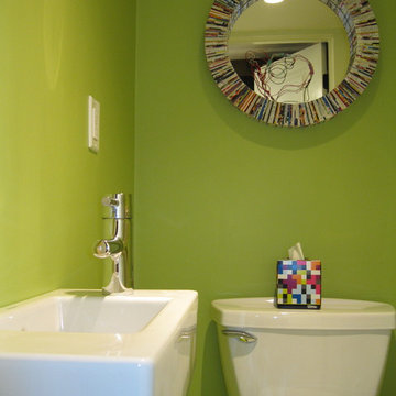 Tiny, bright green powder room with Duravit wall mount sink