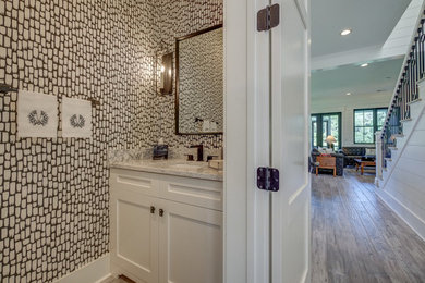 Small transitional brown floor powder room photo in Other with shaker cabinets, white cabinets, a one-piece toilet, multicolored walls, an undermount sink, granite countertops and multicolored countertops