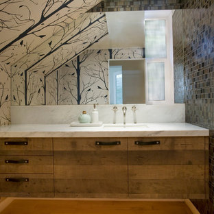 Large eclectic multicolored tile and glass tile light wood floor powder room photo in Dallas with an undermount sink, flat-panel cabinets, distressed cabinets, marble countertops and multicolored walls