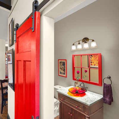 Powder room - mid-sized contemporary dark wood floor powder room idea in Other with a vessel sink, recessed-panel cabinets, a two-piece toilet, gray walls, granite countertops and dark wood cabinets