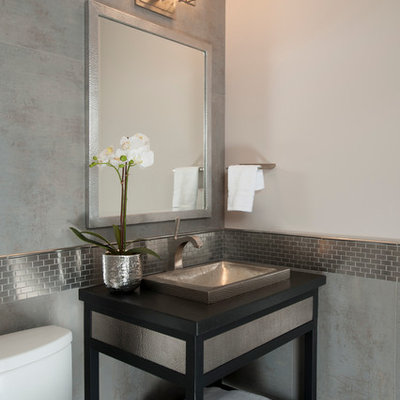 Powder room - transitional gray tile and metal tile powder room idea in San Francisco with a vessel sink, open cabinets, black cabinets, a two-piece toilet and gray walls