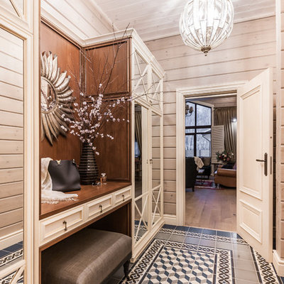 Inspiration for a mid-sized farmhouse ceramic tile, blue floor, wood ceiling and wood wall entryway remodel in Other with beige walls and a brown front door