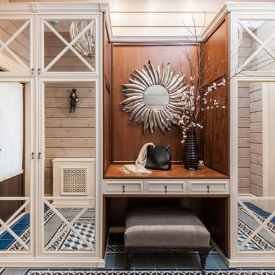 Mid-sized country blue floor, ceramic tile, wood ceiling and wood wall entryway photo in Other with beige walls and a brown front door