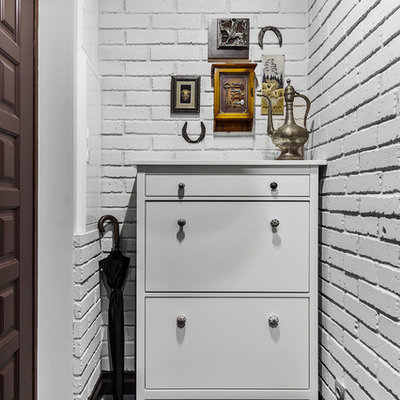 Example of a small classic porcelain tile and gray floor entryway design in Moscow with gray walls and a brown front door