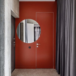 Inspiration för en funkis ingång och ytterdörr, med orange väggar, terrazzogolv, en enkeldörr, en svart dörr och grått golv