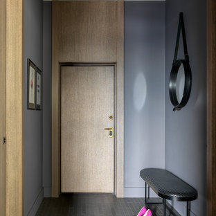 Immagine di una porta d'ingresso minimal di medie dimensioni con pareti viola, pavimento con piastrelle in ceramica, pavimento grigio, una porta singola e una porta in legno chiaro