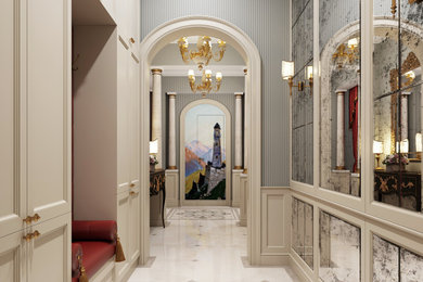 他の地域にあるラグジュアリーなトラディショナルスタイルのおしゃれな玄関ホール (緑の壁、大理石の床、白いドア、ベージュの床、パネル壁) の写真