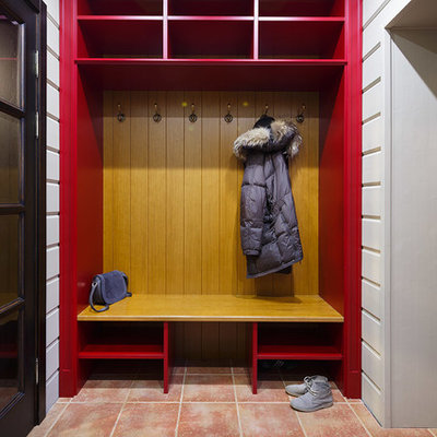 Example of a country brown floor mudroom design in Saint Petersburg with white walls