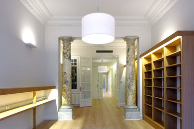 Ejemplo de recibidores y pasillos tradicionales grandes con paredes blancas y suelo de madera en tonos medios