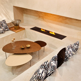 Contemporary games room in Other with marble flooring, a ribbon fireplace and a stone fireplace surround.