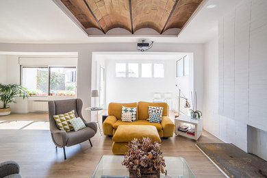 Example of a large danish open concept light wood floor family room design in Barcelona with white walls, a standard fireplace, a brick fireplace and a corner tv