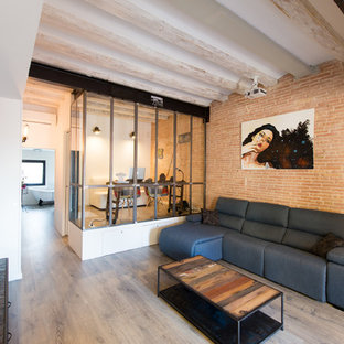 Mittelgroßes Industrial Wohnzimmer ohne Kamin mit oranger Wandfarbe und hellem Holzboden in Barcelona