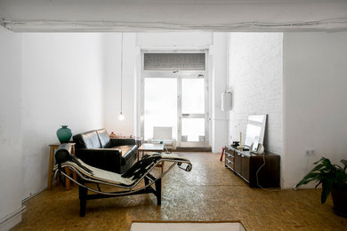 Example of a mid-sized 1960s open concept plywood floor family room design in Valencia with white walls, no fireplace and no tv