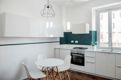 Immagine di una piccola sala da pranzo aperta verso la cucina design con pareti bianche, pavimento in legno massello medio e pavimento marrone