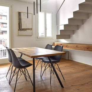 Idee per una sala da pranzo aperta verso la cucina minimalista di medie dimensioni con pareti bianche, pavimento in legno massello medio e pavimento marrone