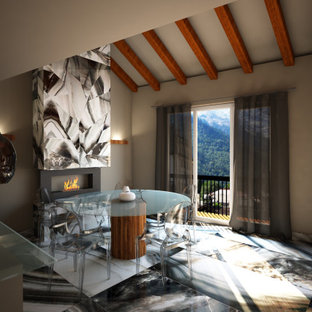 Immagine di un'ampia sala da pranzo aperta verso la cucina minimalista con pareti beige, pavimento in gres porcellanato, camino sospeso, cornice del camino piastrellata e pavimento multicolore